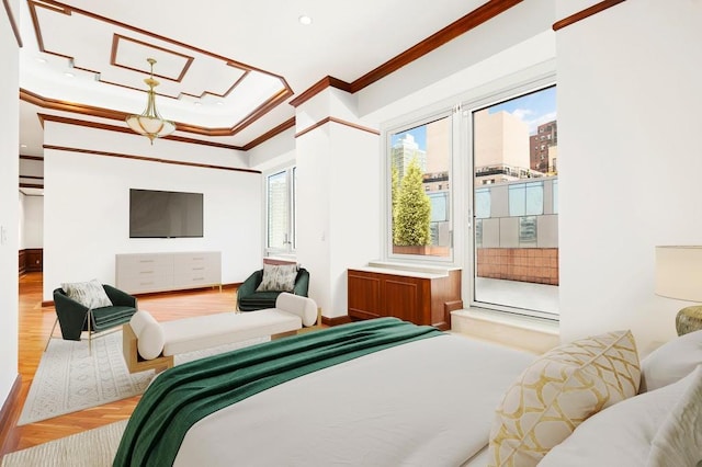 bedroom featuring multiple windows, light wood-type flooring, and crown molding