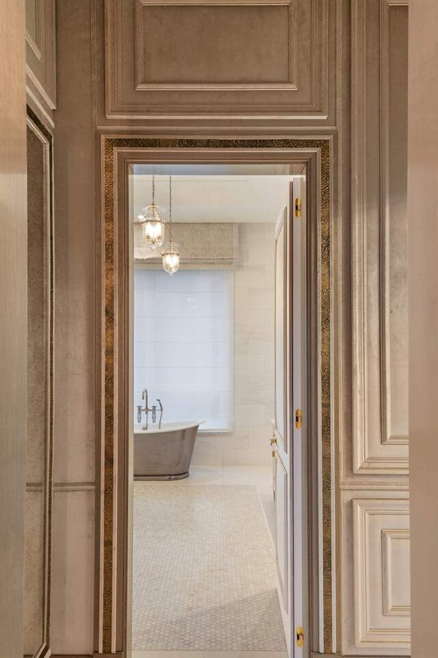 hall featuring light tile patterned floors