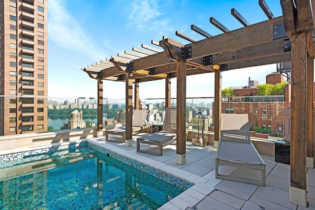 view of swimming pool with a pergola and a water view