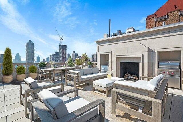 view of patio featuring an outdoor living space with a fireplace and area for grilling