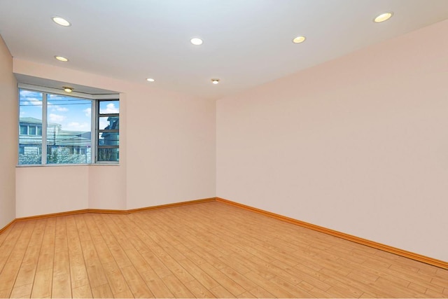 spare room with light hardwood / wood-style flooring