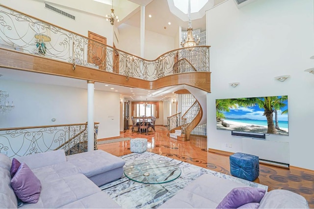 living room with a towering ceiling and a chandelier