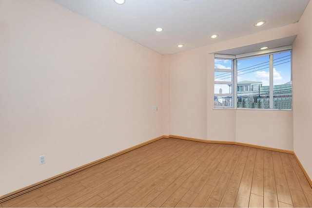 unfurnished room with light hardwood / wood-style flooring