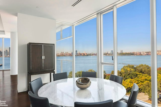 sunroom featuring a water view