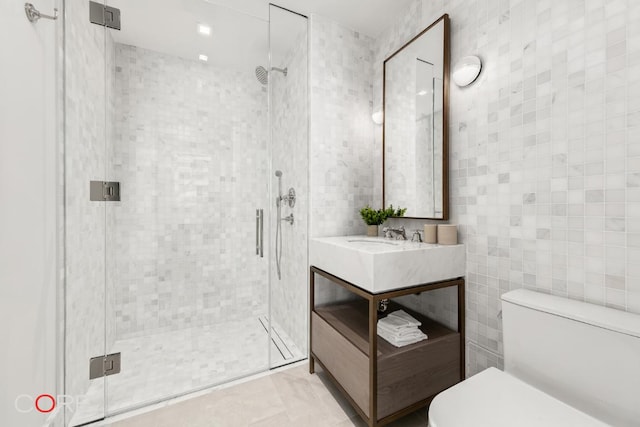 bathroom featuring a shower with shower door, tile walls, and toilet