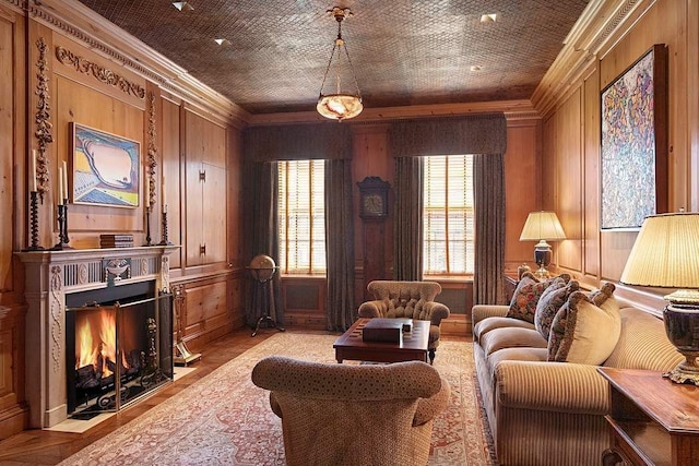 living room featuring crown molding, wooden walls, and light hardwood / wood-style floors