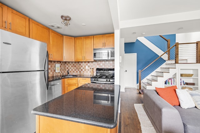 kitchen with backsplash, dark wood-type flooring, stainless steel appliances, and sink