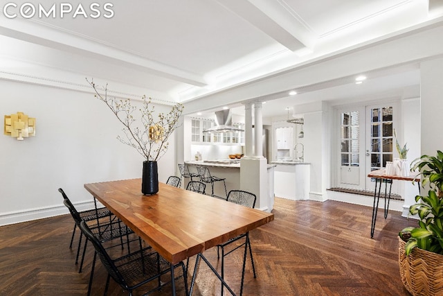 dining space featuring french doors, beam ceiling, dark parquet floors, and sink