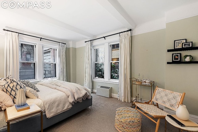 carpeted bedroom with beamed ceiling