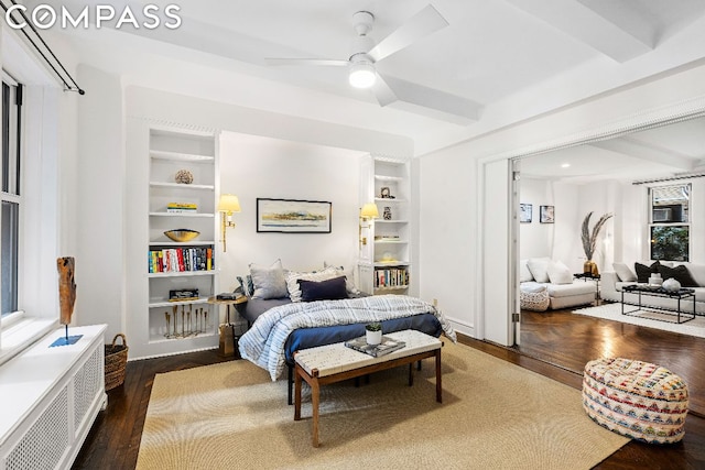 bedroom with radiator, ceiling fan, beam ceiling, and dark wood-type flooring