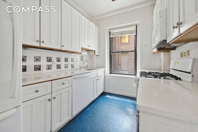 kitchen featuring decorative backsplash, white appliances, white cabinetry, and a sink