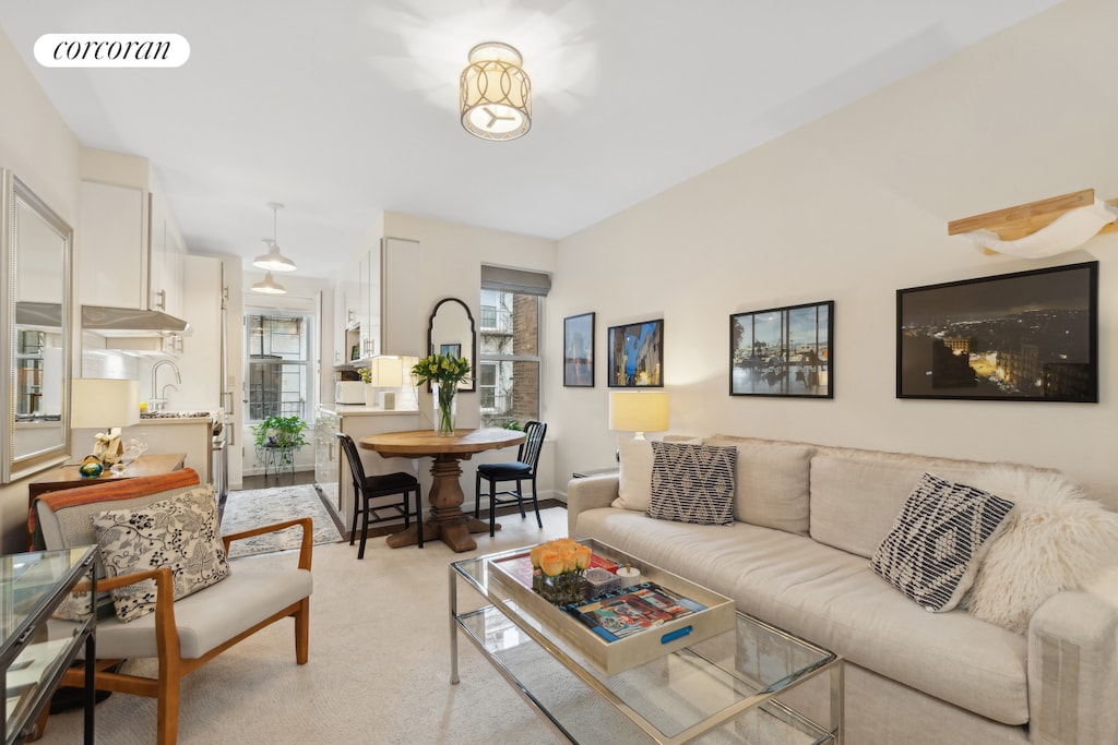 living room featuring light carpet and visible vents