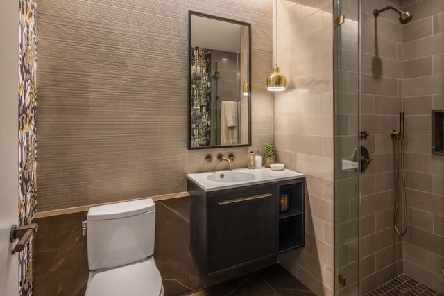 bathroom featuring toilet, vanity, tile walls, and walk in shower