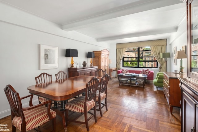 dining space featuring beam ceiling and dark parquet flooring