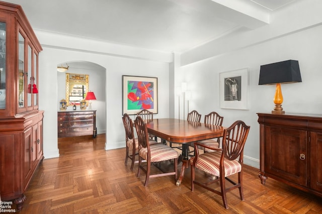 dining space with dark parquet flooring