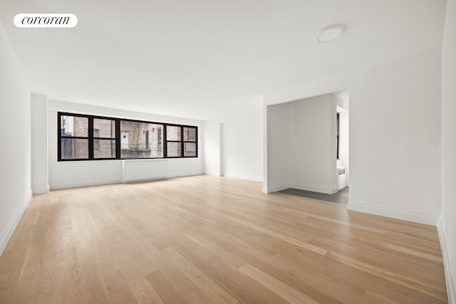 empty room with light hardwood / wood-style floors