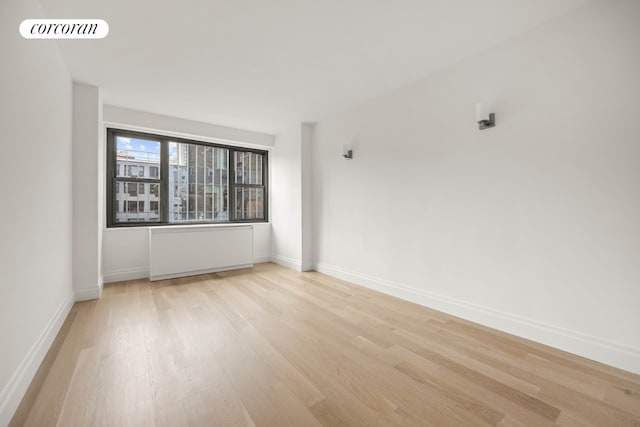 spare room featuring light hardwood / wood-style floors