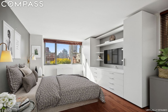 bedroom with dark wood-type flooring