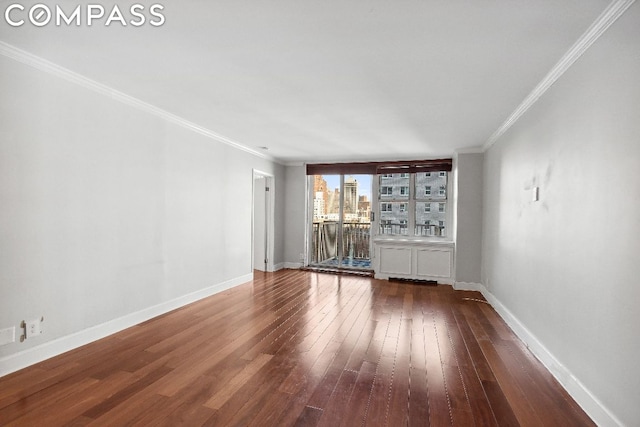 spare room featuring wood-type flooring and ornamental molding