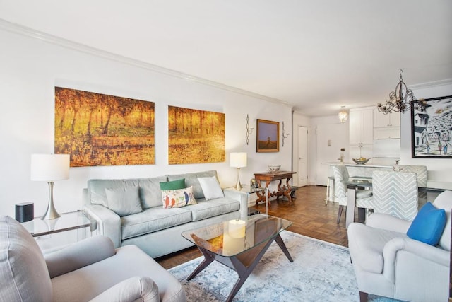 living room featuring an inviting chandelier, parquet flooring, and ornamental molding