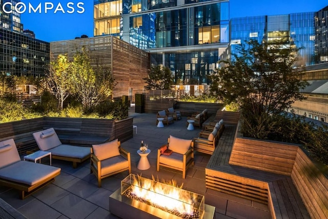 view of patio / terrace featuring an outdoor living space with a fire pit