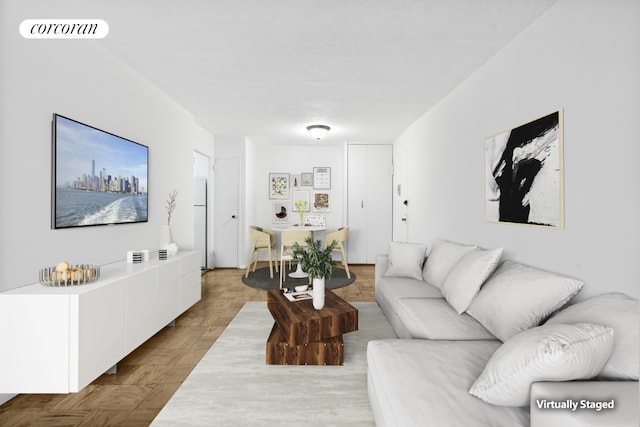 living room with light parquet flooring and a textured ceiling