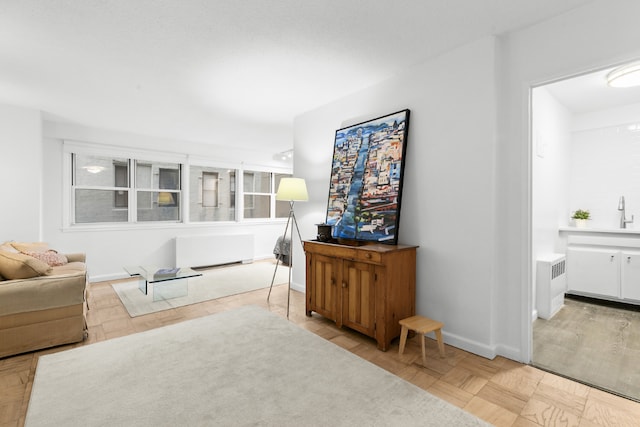 sitting room featuring light parquet flooring and radiator