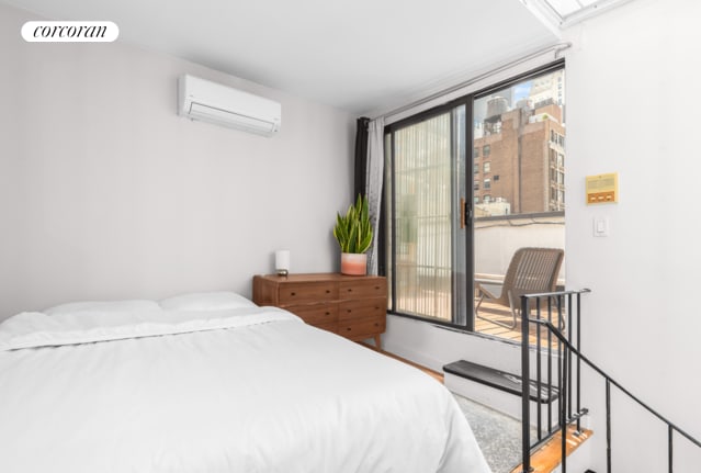 bedroom featuring an AC wall unit