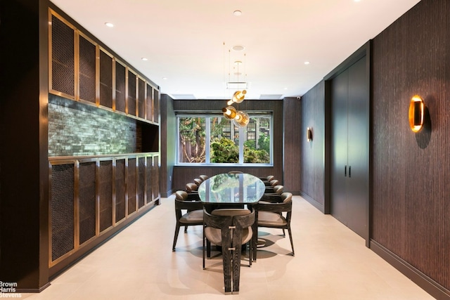 dining room featuring wood walls