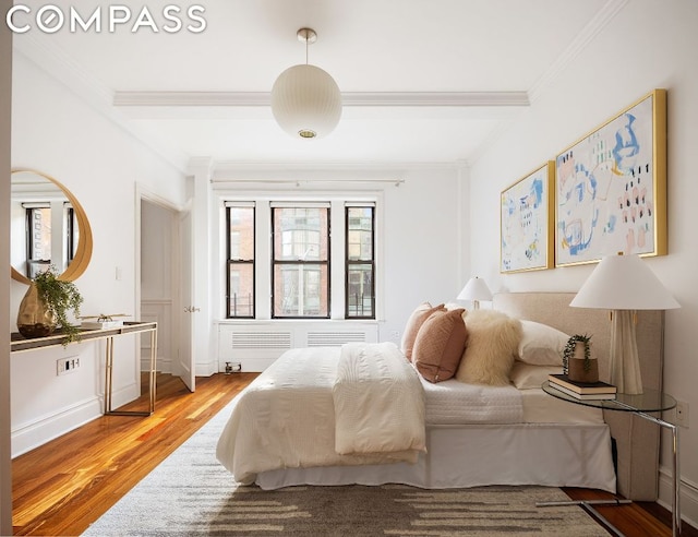 bedroom featuring crown molding and hardwood / wood-style flooring