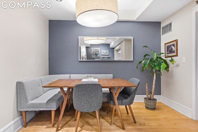 dining space featuring wood-type flooring