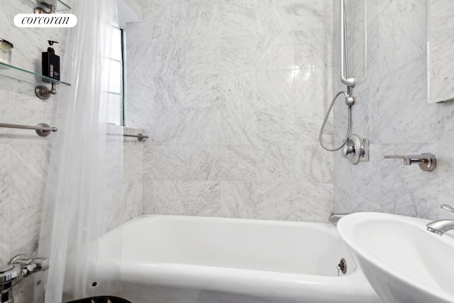 full bathroom with shower / bath combo and a sink