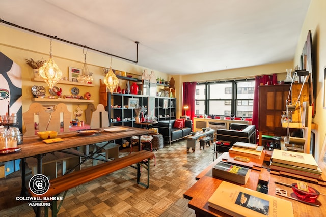 interior space featuring decorative light fixtures and parquet flooring