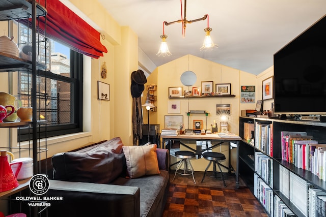 office with dark parquet flooring and vaulted ceiling