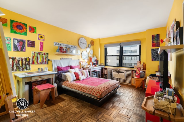 bedroom featuring a wall unit AC and parquet floors