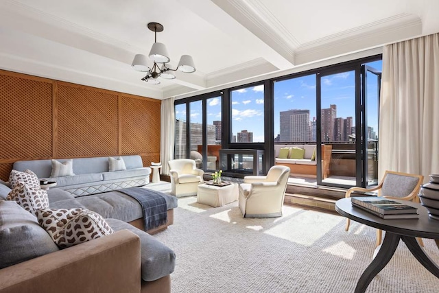 living area featuring carpet, ornamental molding, beam ceiling, an inviting chandelier, and a view of city