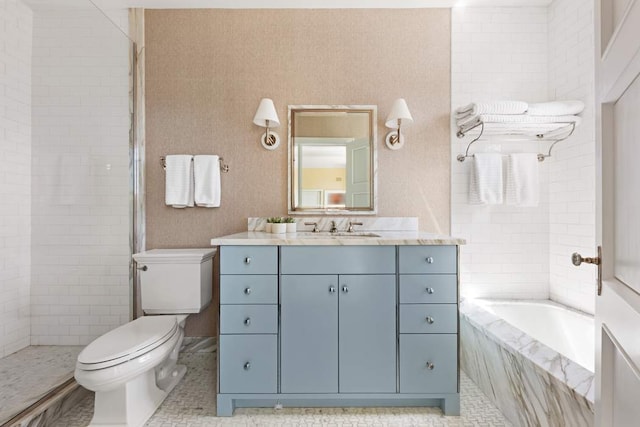 bathroom with vanity, toilet, a bathtub, and a tile shower