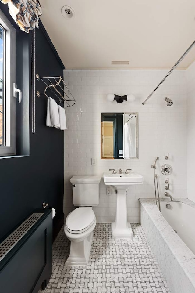 1130 Park Ave Ph-A, Ph-A New York City, NY 10128 - bathroom featuring tiled shower / bath, tile walls, and toilet
