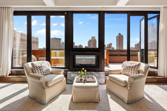 sunroom / solarium featuring a city view and a glass covered fireplace