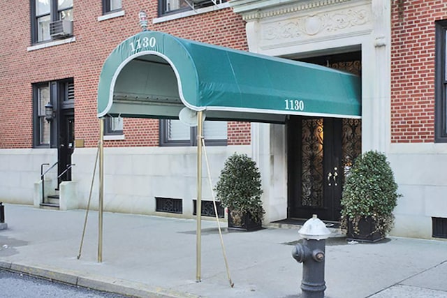 entrance to property with brick siding