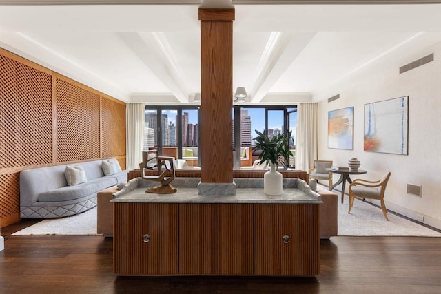 kitchen featuring beamed ceiling, a kitchen island, dark wood-type flooring, and open floor plan