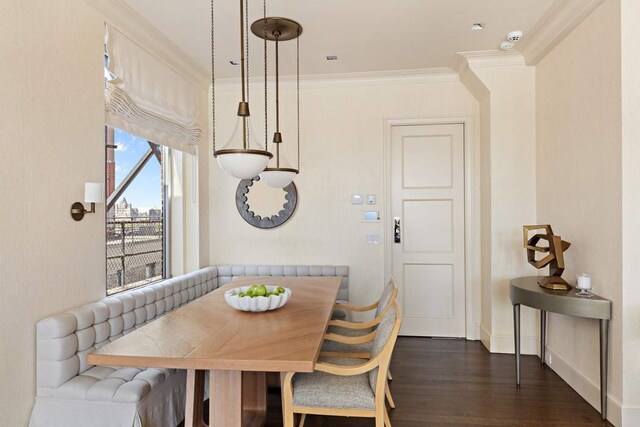 dining space with breakfast area, ornamental molding, and dark wood-type flooring