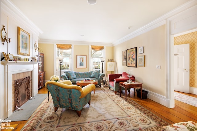 living area featuring light hardwood / wood-style flooring, a fireplace, and ornamental molding