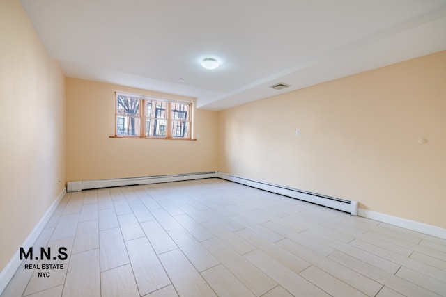 spare room featuring light wood-style flooring, visible vents, and baseboards