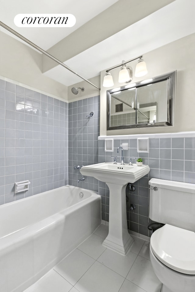 bathroom featuring tub / shower combination, tile walls, toilet, and tile patterned floors