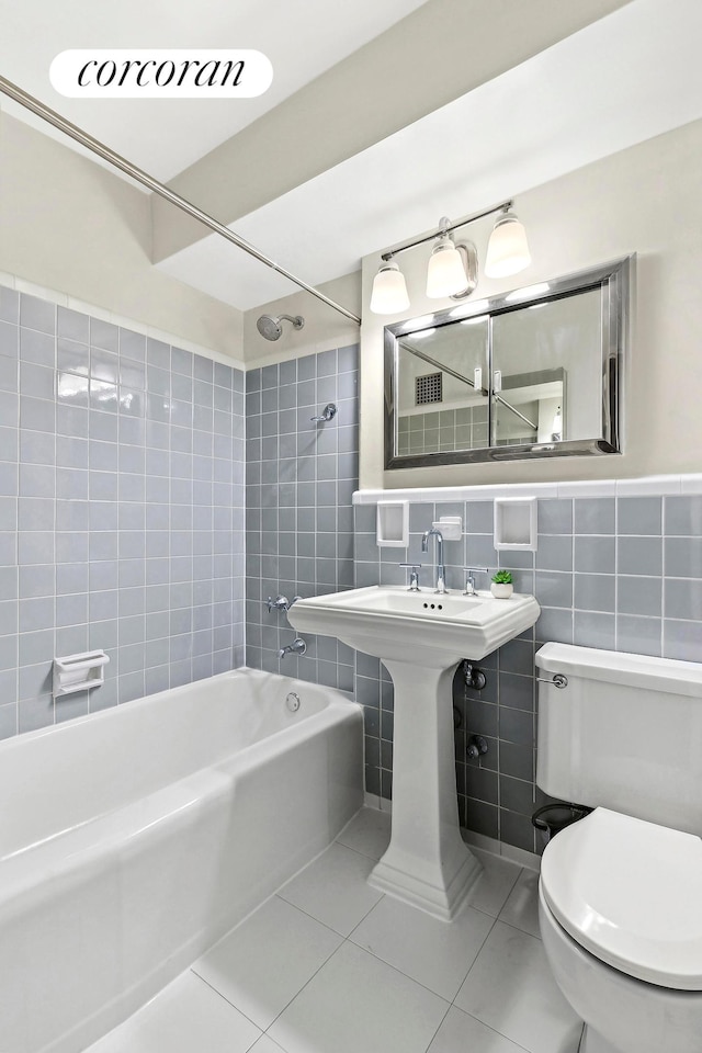 240 E 76th St Unit 1U, New York City, NY 10021 - full bathroom featuring tile walls, tile patterned floors, tub / shower combination, and toilet