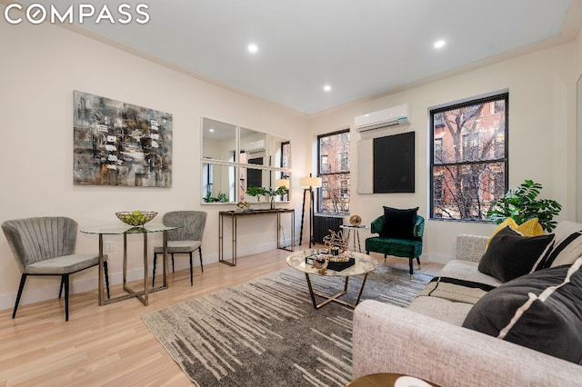 living room with light hardwood / wood-style floors and a wall mounted air conditioner