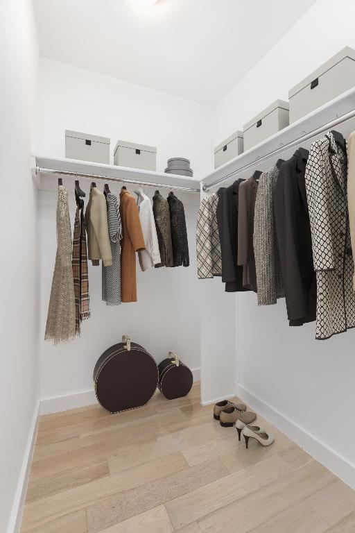 mudroom featuring light wood finished floors and baseboards