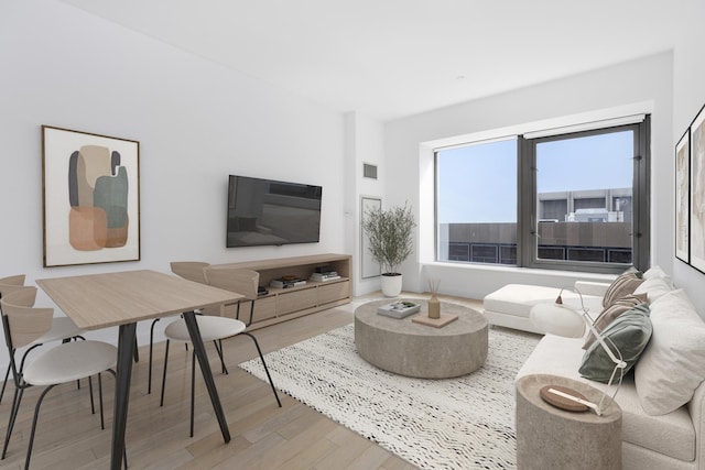 living room with light wood-type flooring and visible vents