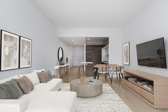 living room featuring light wood-type flooring and recessed lighting